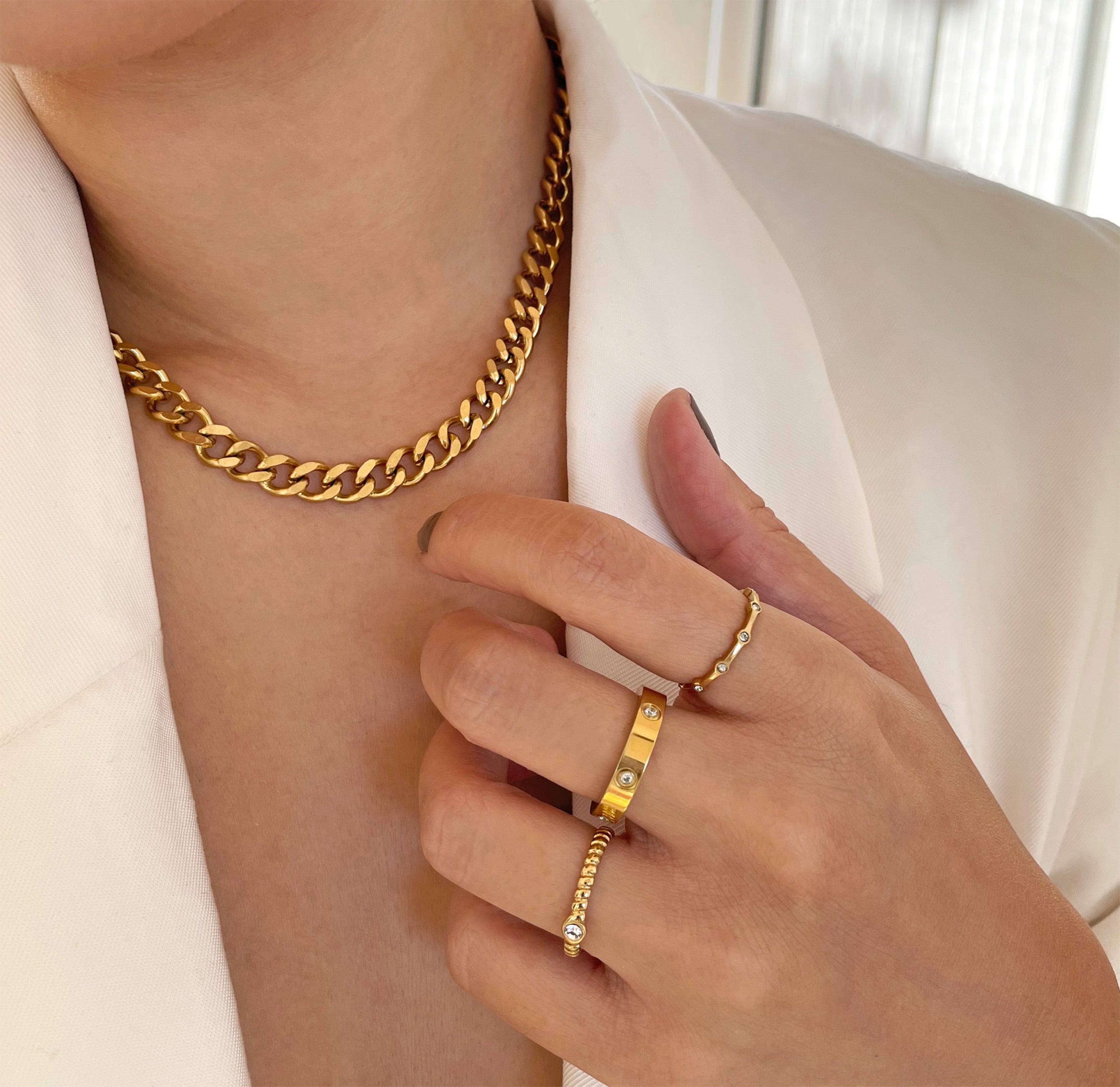 gold stackable rings worn on models with roslyn medium curb necklace waterproof jewelry