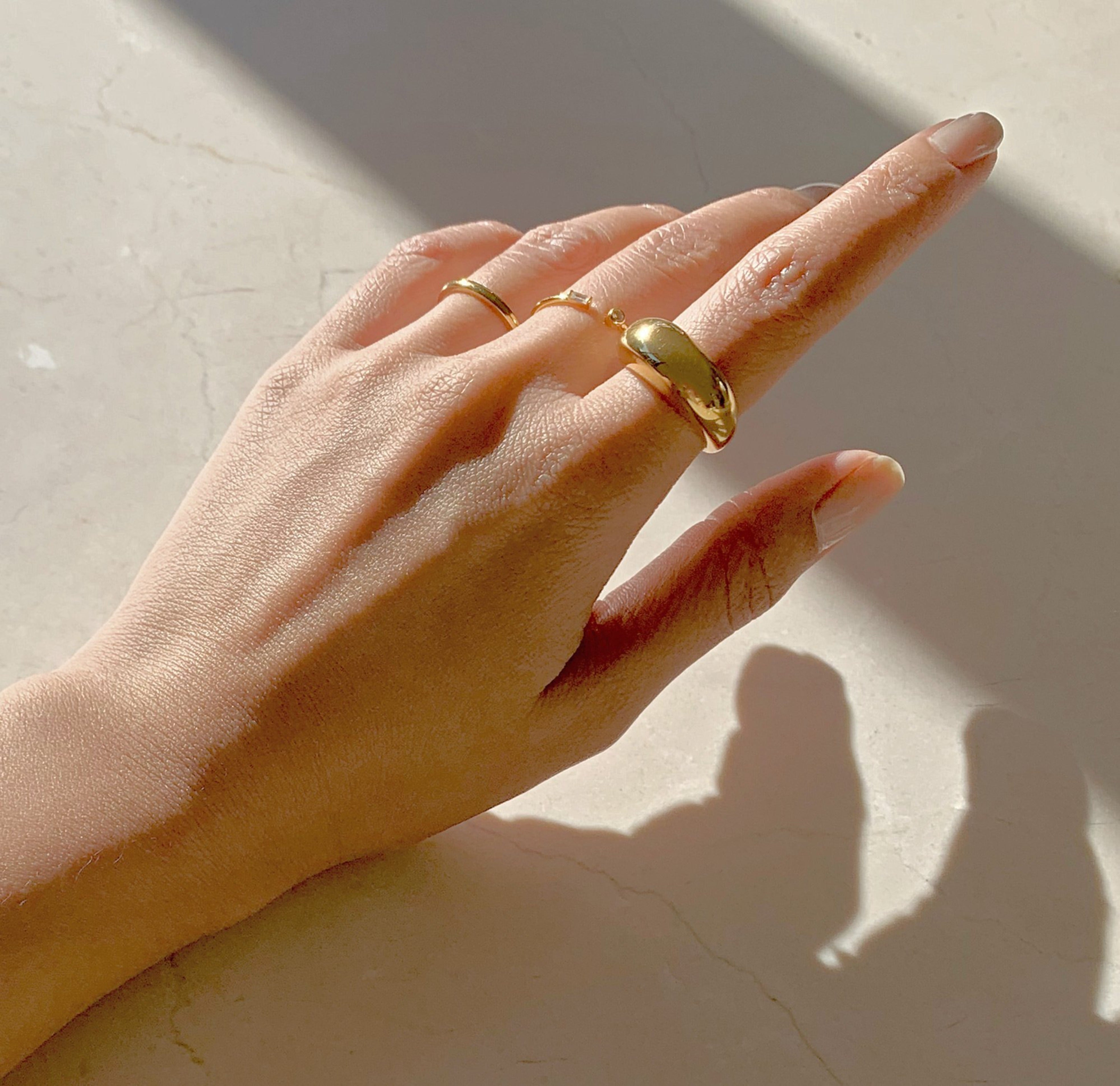 Didi thin gold ring band paired with Capri gold dome ring, waterproof rings