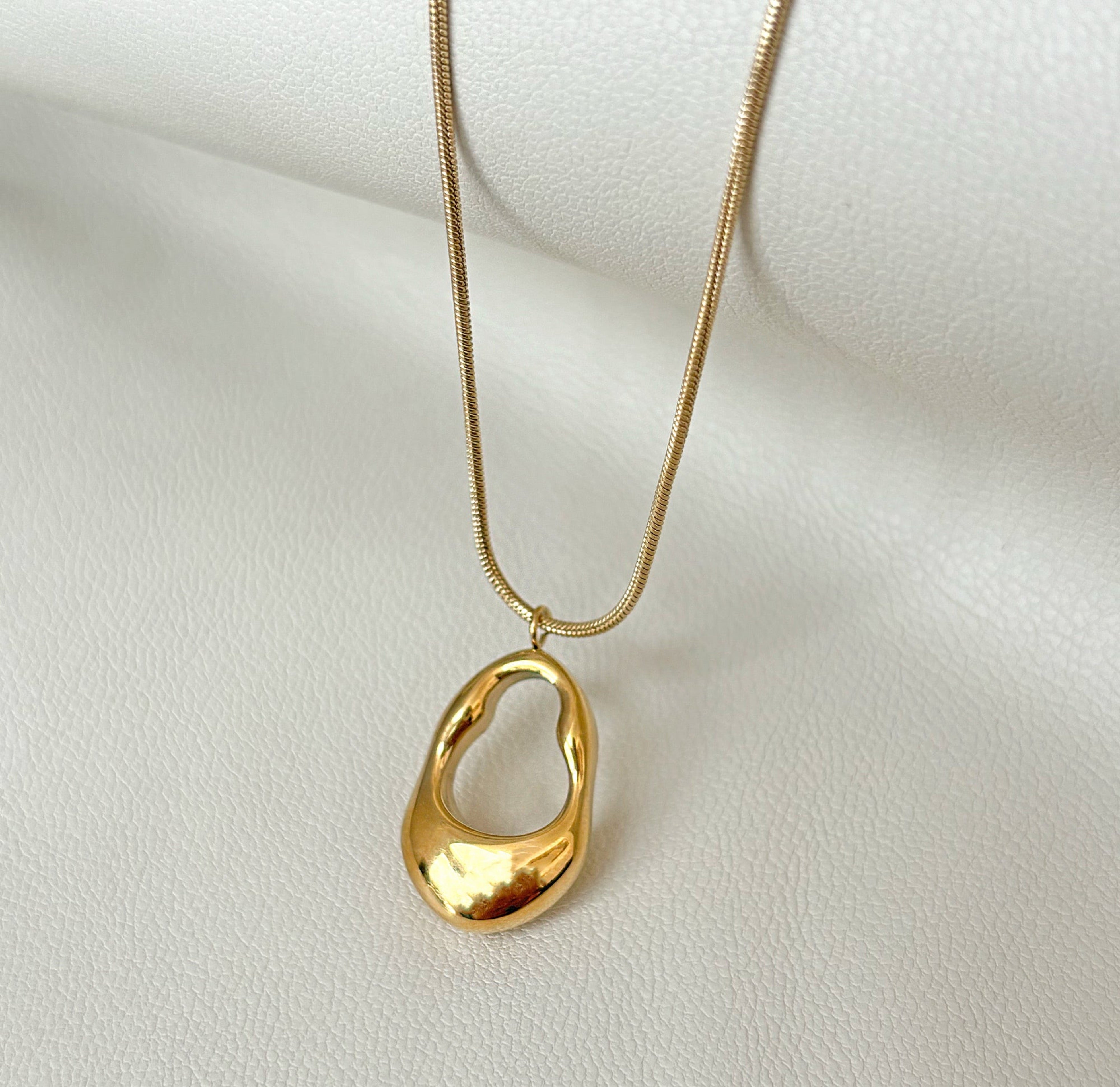 gold oval abstract pendant necklace sample