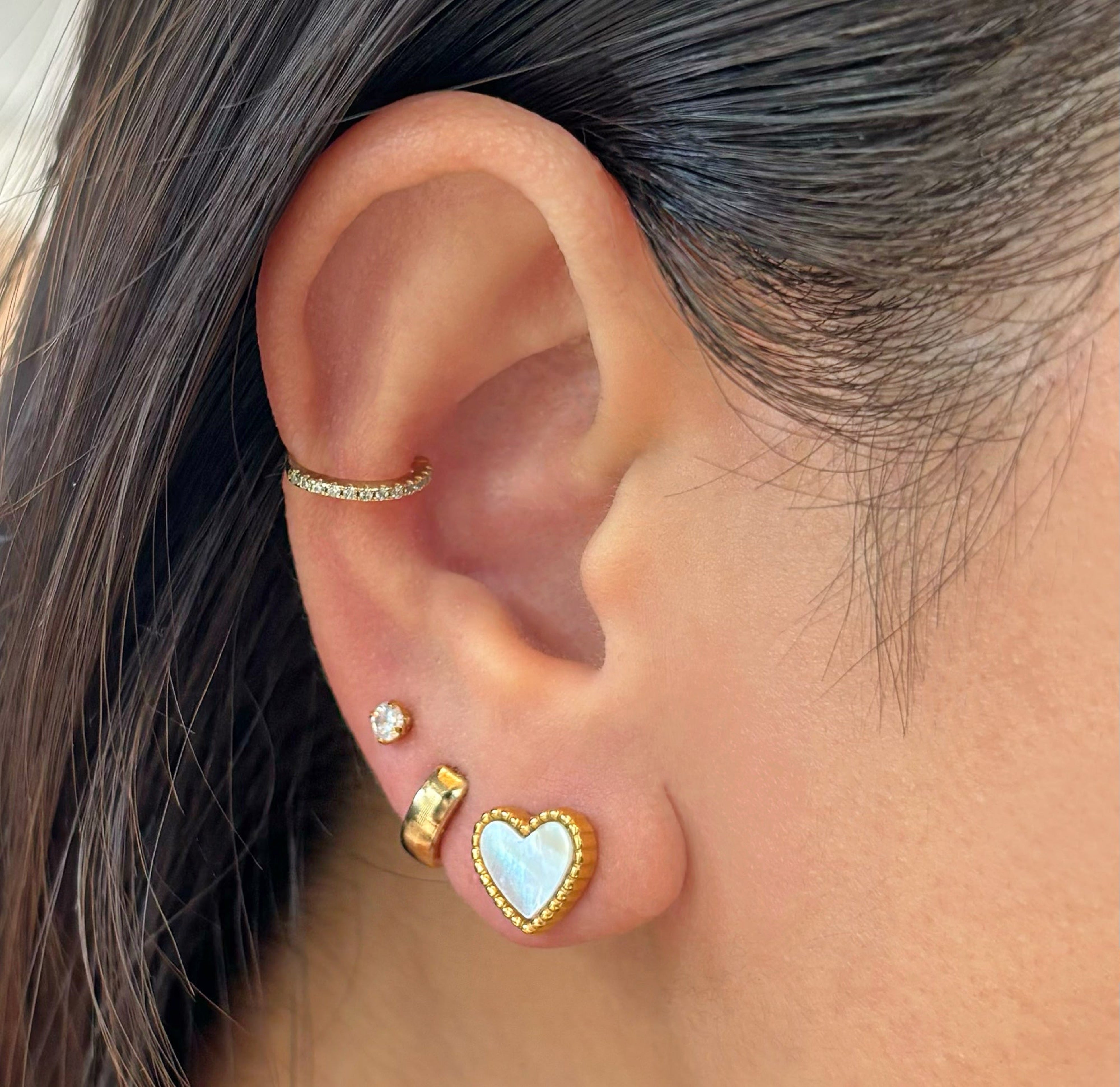gold heart shell stud earrings worn on model waterproof jewelry