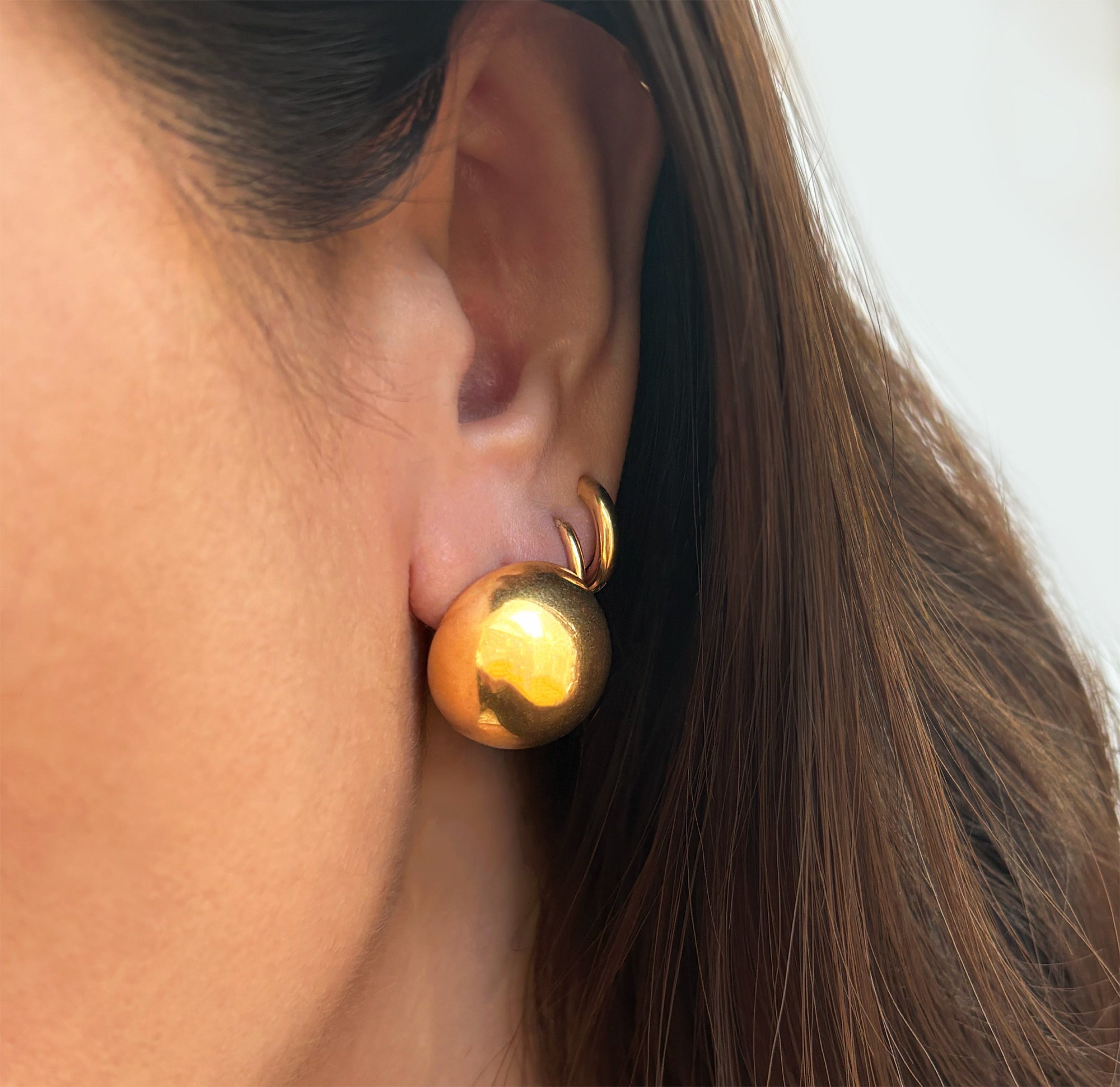 gold dome large circle earrings worn on model tarnish free jewelry