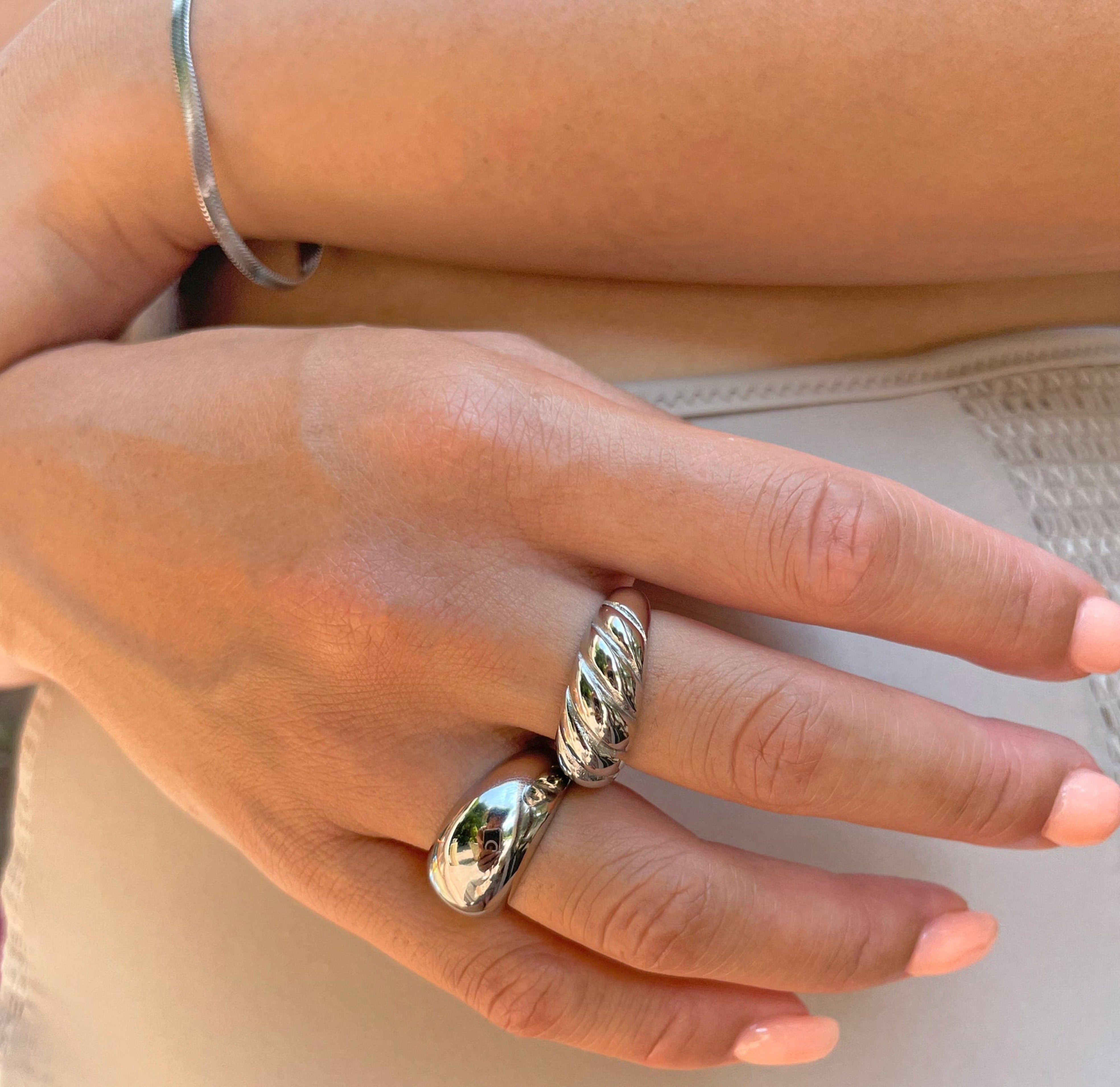 thick silver bubble ring paired with silver croissant ring. silver waterproof jewelry