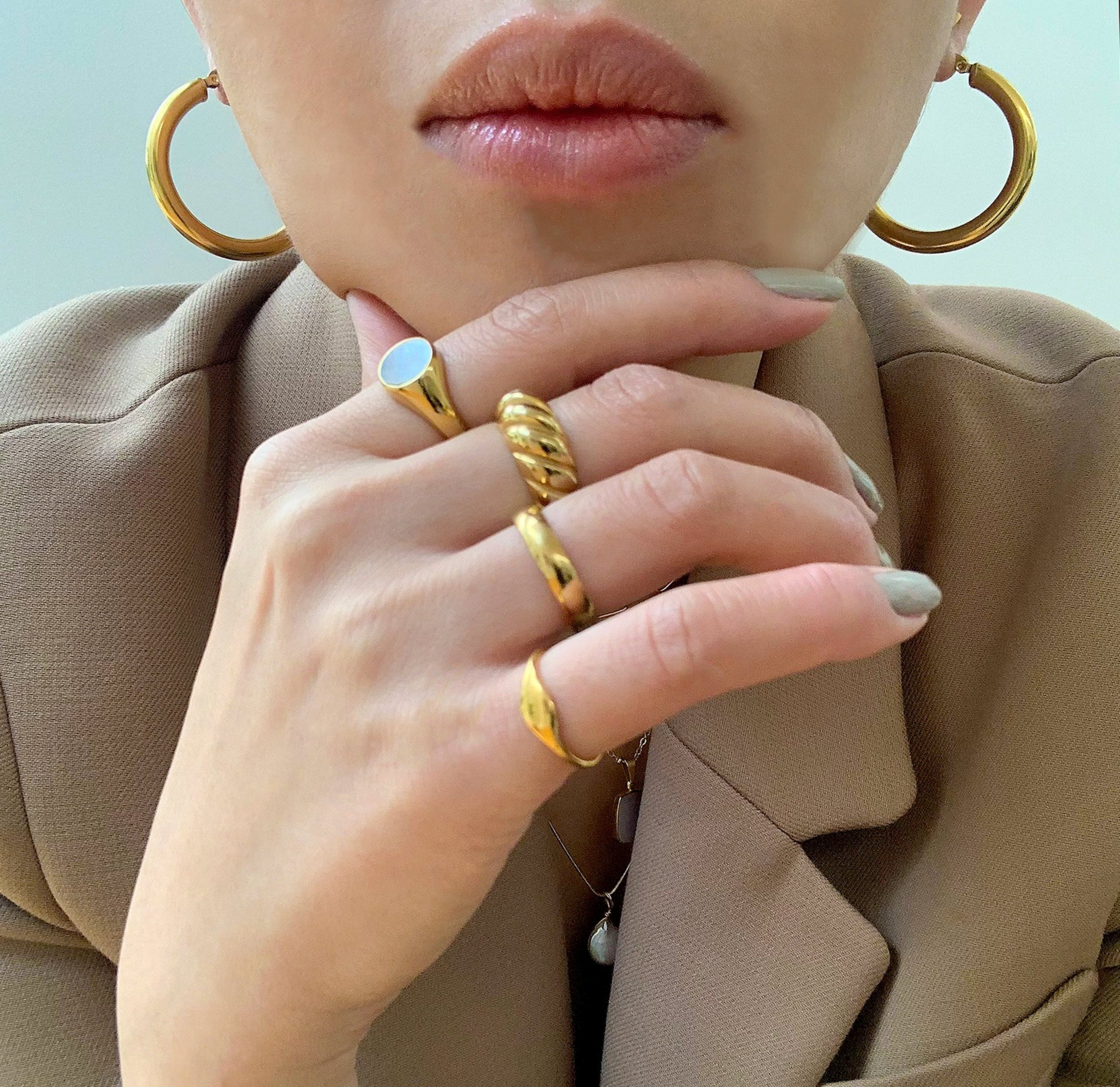 Gold classic croissant ring worn on model. Waterproof rings