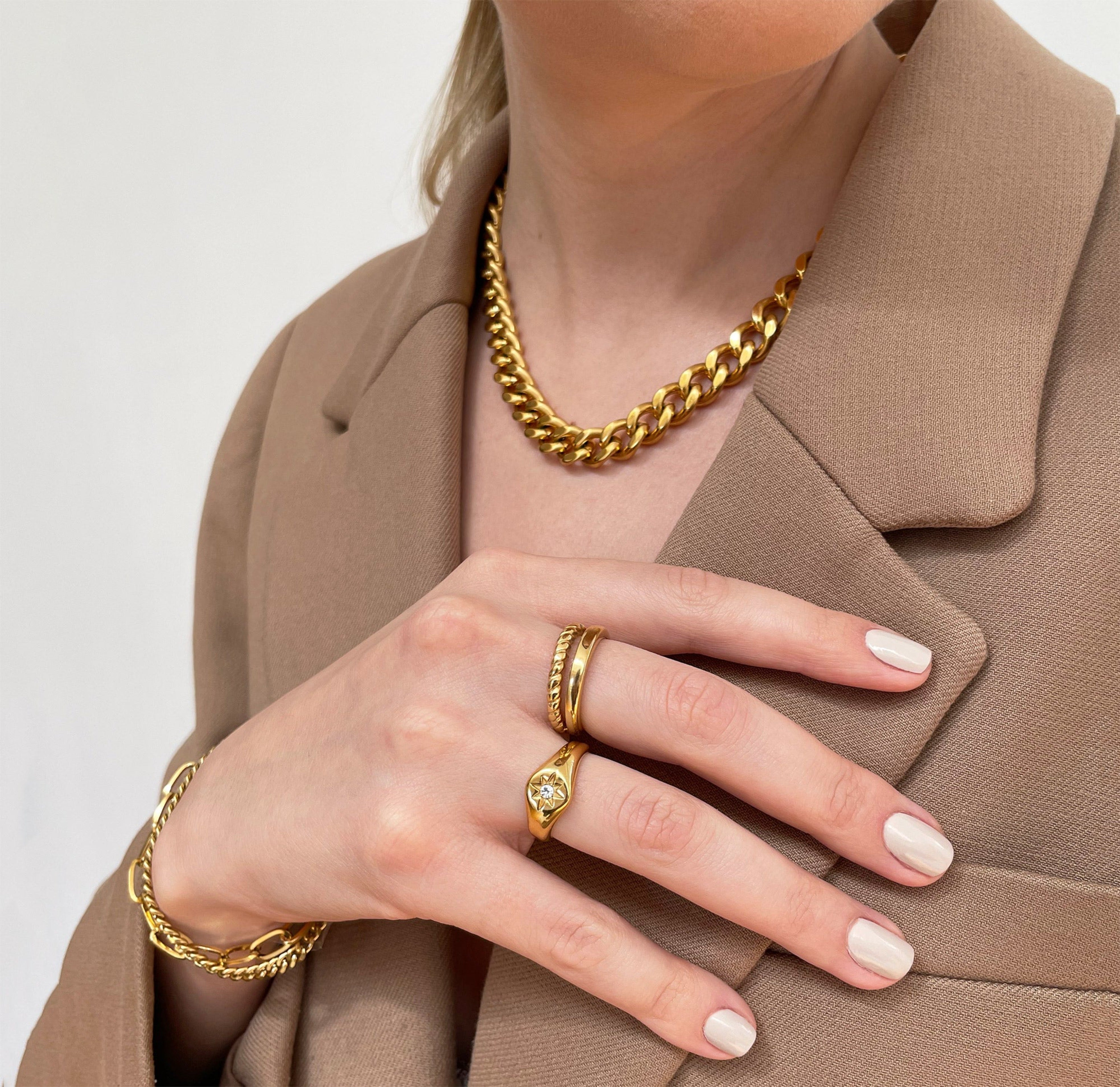 August gold star signet ring worn with the gold duo stack birdy ring . The jewelry is worn on a model and they are water resistant jewelry