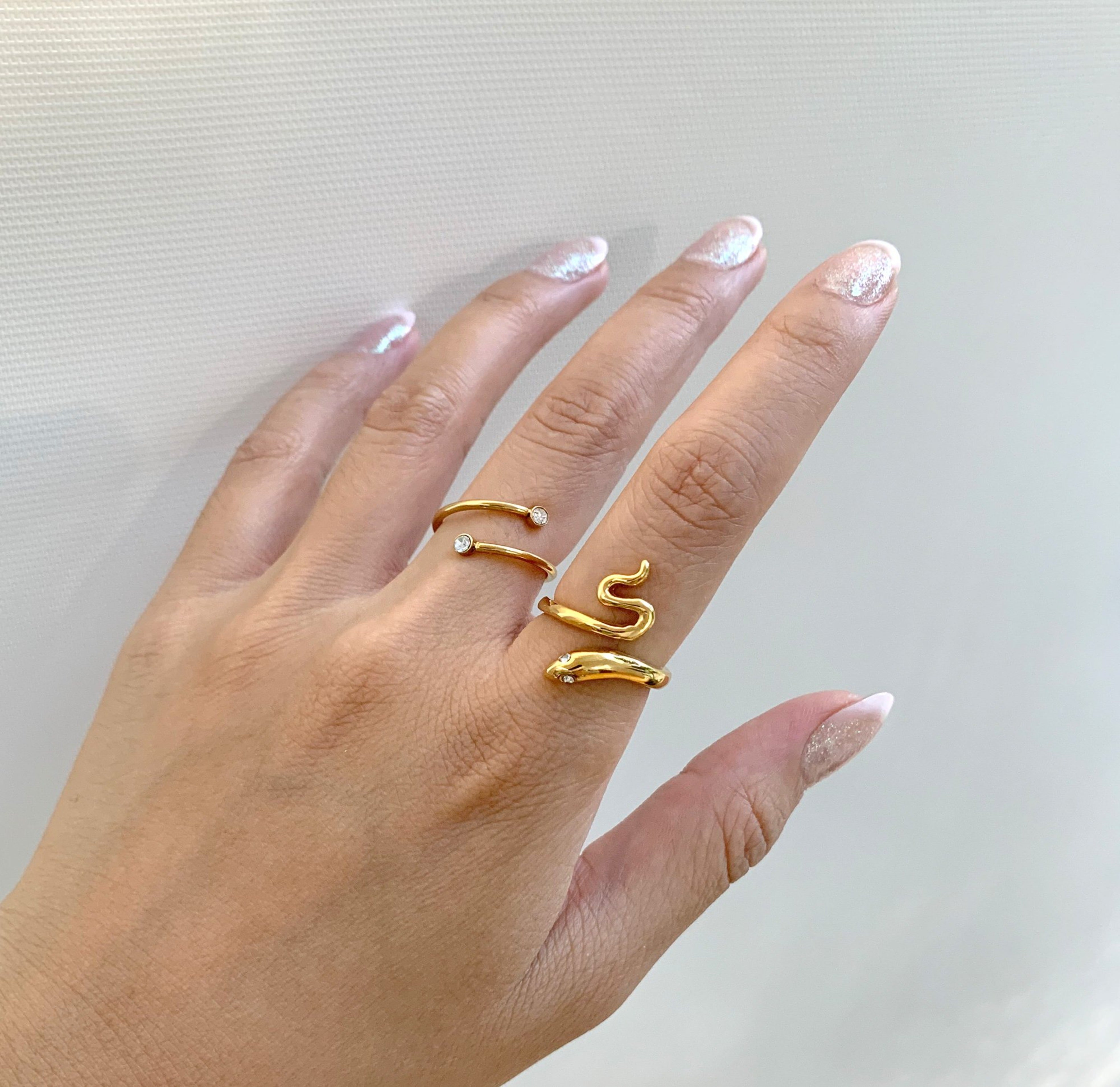 gold snake ring paired with Sylvie spiral gold ring. Waterproof jewelry
