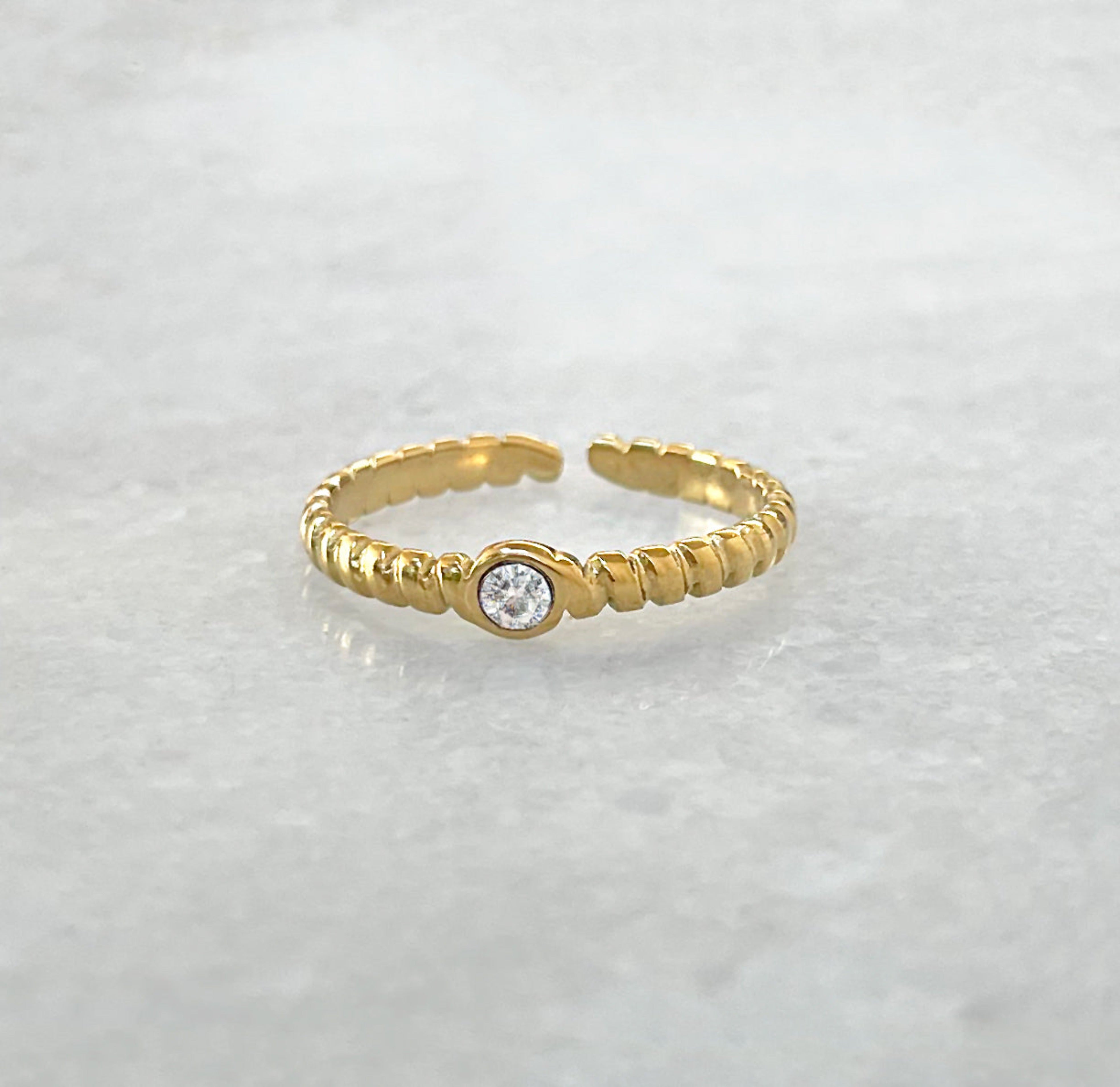 Helena gold adjustable solitaire ring paired with Daphne pave ring, and Carrie ring band. Gold waterproof jewelry