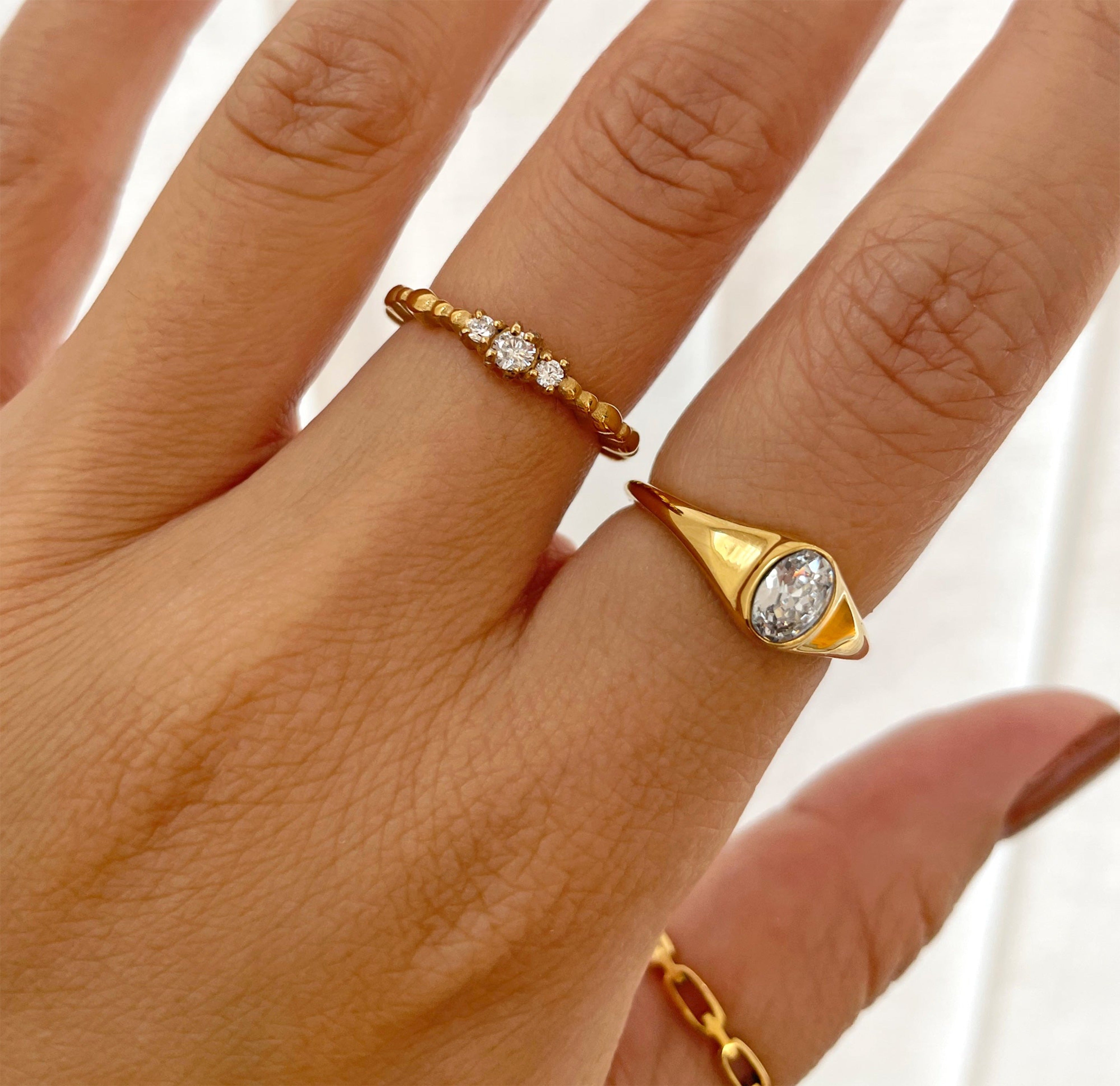 Jeanie gold oval stone ring paired with Celeste dainty trim stone ring. Waterproof jewelry