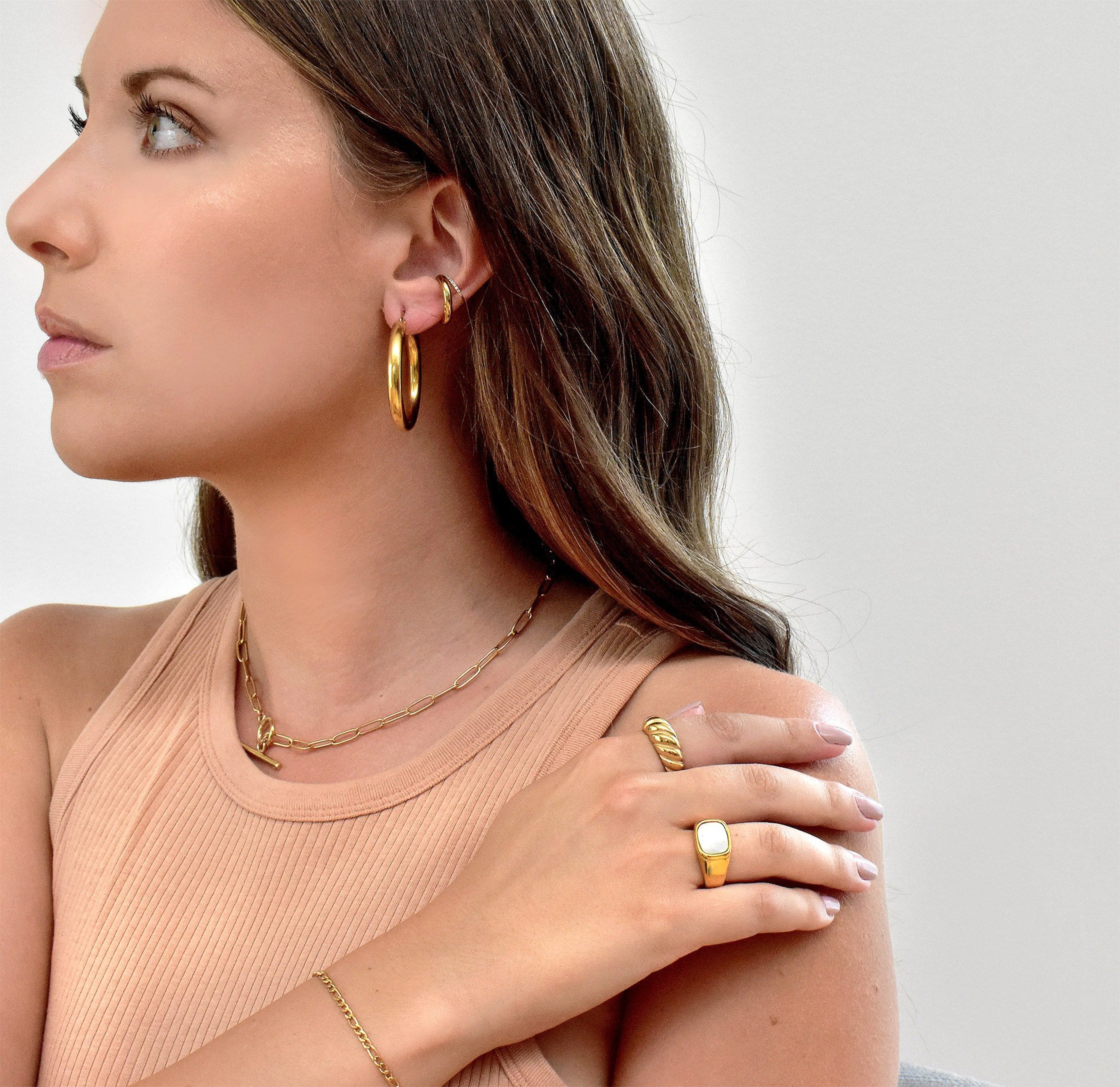 Gold classic croissant ring paired with Thea pearl signet ring worn on model. Waterproof rings