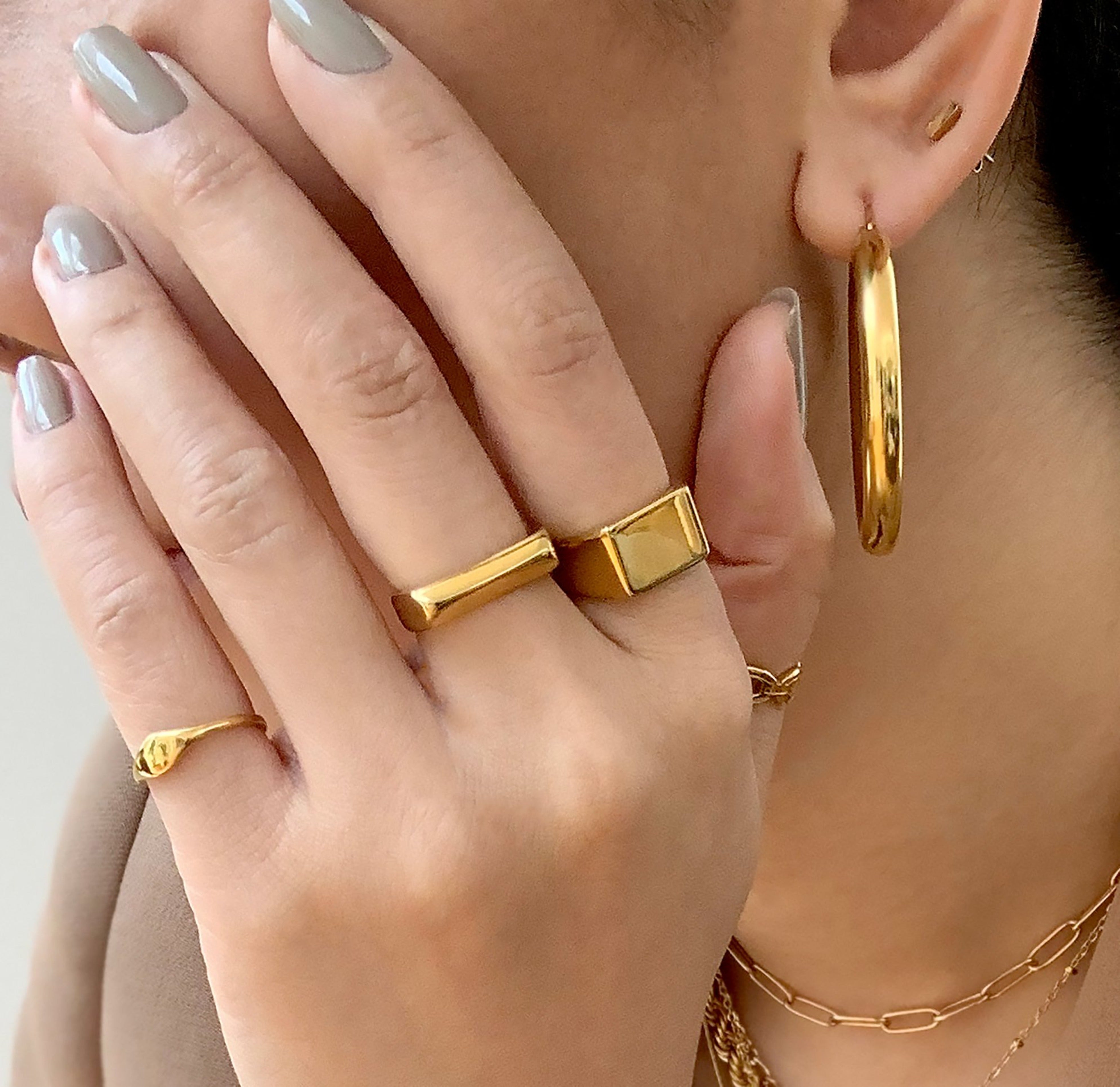 Drew dainty gold signet pink ring paired with Frankie signet ring worn on model, waterproof rings